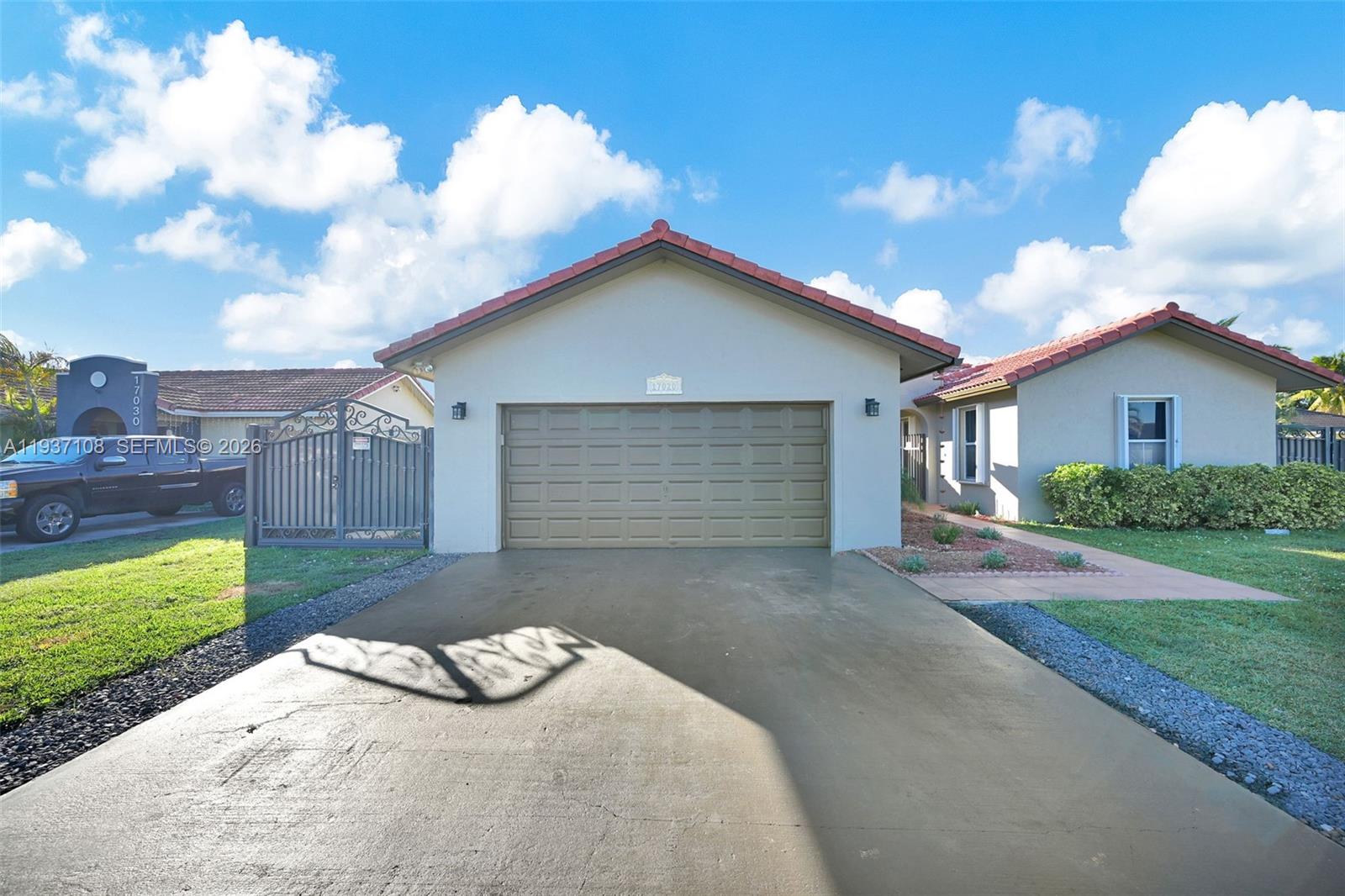 17020 Southwest 149th Avenue Miami, FL 33187 - Photo 8 of 68 a front view of a house with a yard and garage