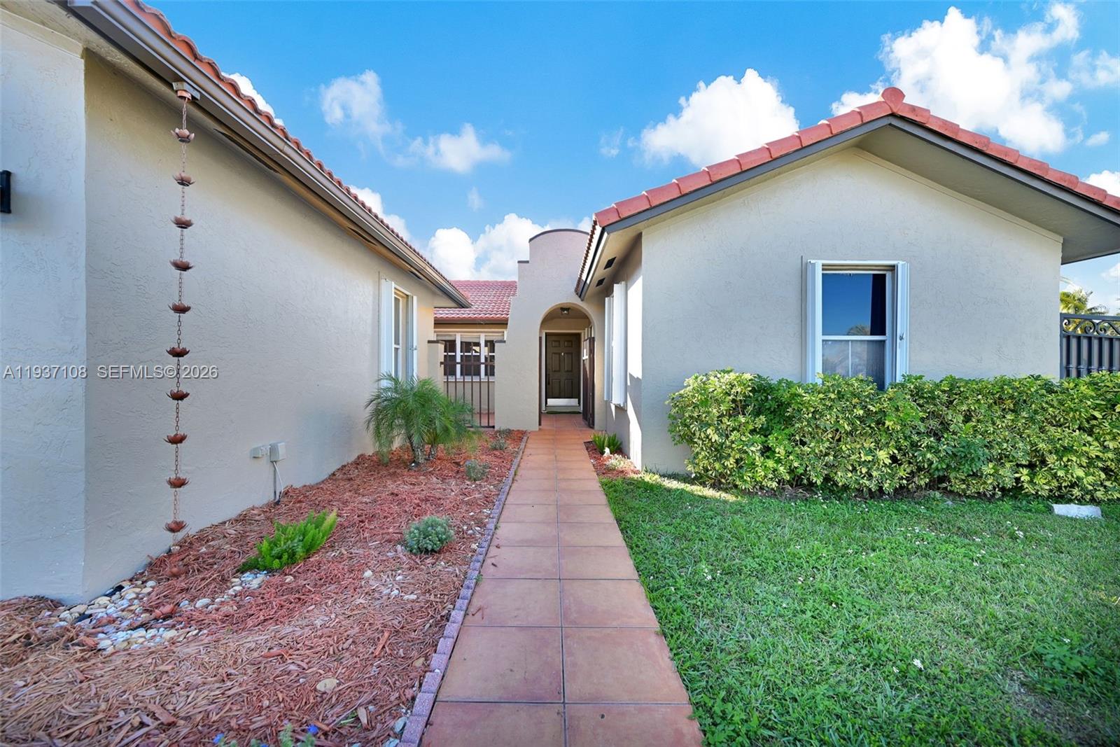 17020 Southwest 149th Avenue Miami, FL 33187 - Photo 9 of 68 a front view of a house with a yard
