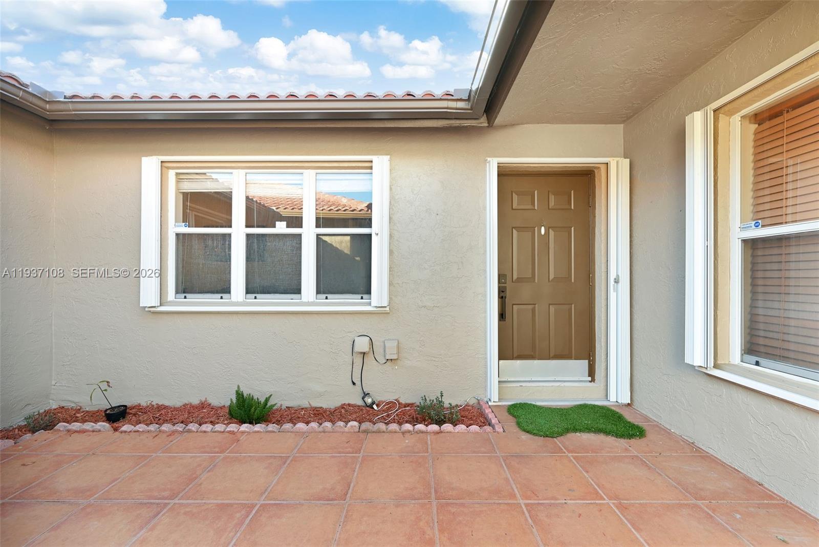 17020 Southwest 149th Avenue Miami, FL 33187 - Photo 10 of 68 a front view of a house with a yard and garage