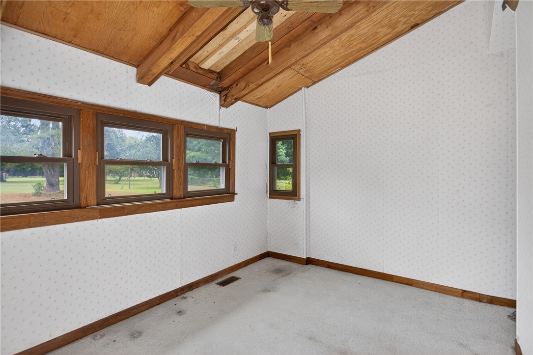112 Holliday Lane Pendleton, SC 29670 - Photo 17 of 42 A cozy bedroom with a warm wooden ceiling, offering views of the peaceful outdoors.