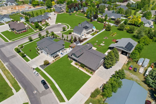 580 North 300 East Logan, UT 84321 - Photo 6 of 74 Spacious property featuring a large concrete driveway, expansive green lawn, and a multi-car garage