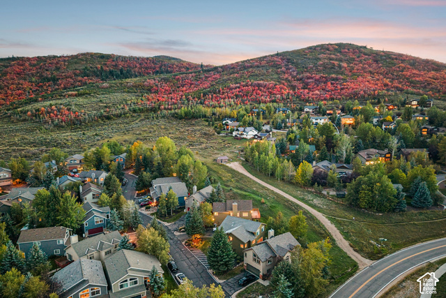 7396 Brook Hollow Loop Road Park City, UT 84098 - Photo 50 of 60 Lush mountainous terrain with autumnal foliage surrounding a residential area, featuring an asphalt road and established trees