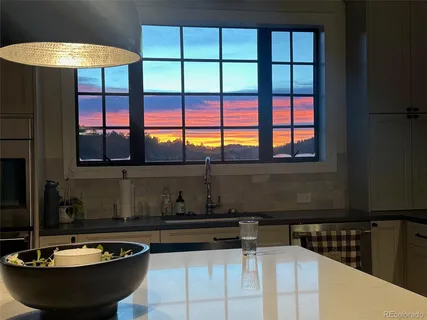 a large kitchen with a table and chairs