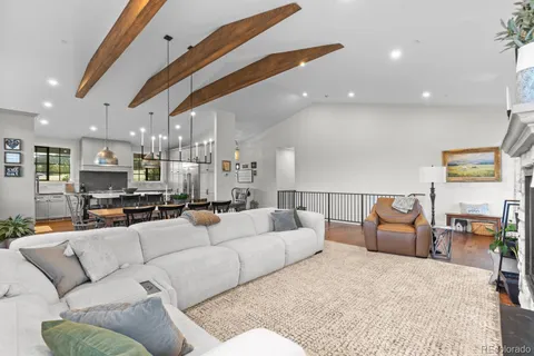 a living room with furniture a window and kitchen view