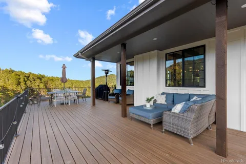 a view of deck with chairs and wooden floor