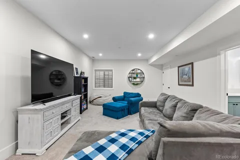 a living room with fireplace furniture and a flat screen tv