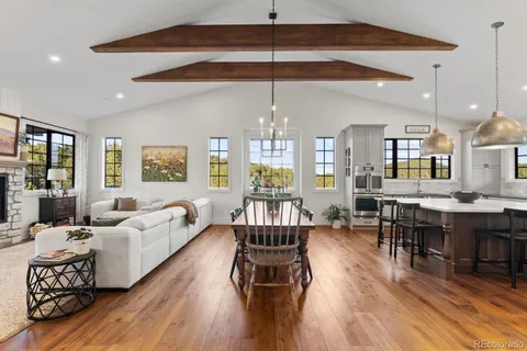 a view of a dining room with furniture and a chandelier