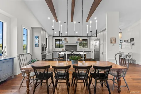 a kitchen with counter space dining table and chairs