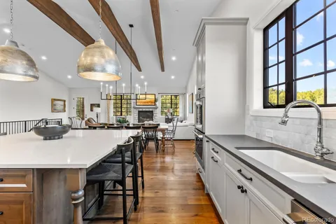a kitchen with stainless steel appliances granite countertop a sink stove and cabinets