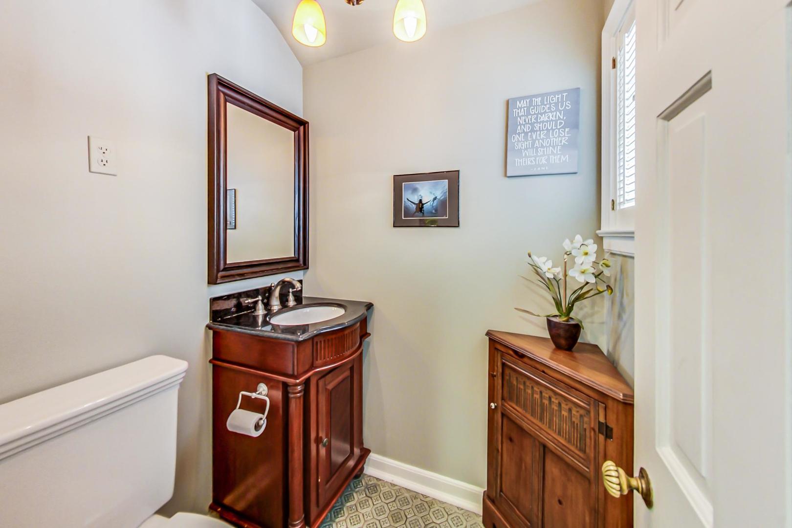 875 Fairview Road Highland Park, IL 60035 - Photo 16 of 32 a bathroom with a toilet a sink and mirror