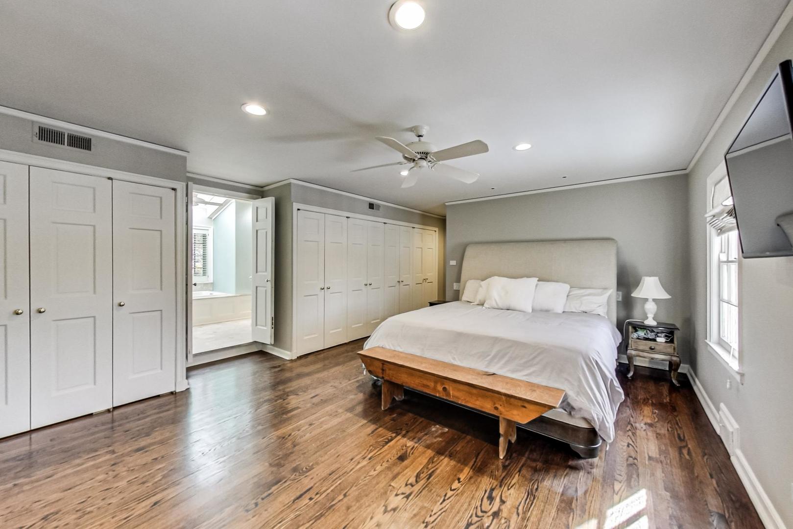 875 Fairview Road Highland Park, IL 60035 - Photo 17 of 32 a spacious bedroom with a bed and a wooden floor