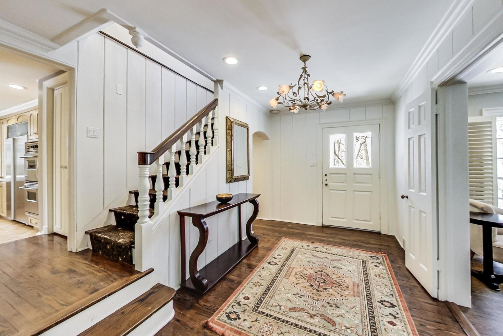 875 Fairview Road Highland Park, IL 60035 - Photo 2 of 32 a view of an entryway with wooden floor and a front door