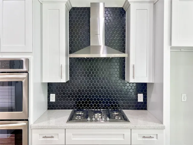 a kitchen with a stove and cabinets