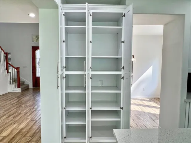 a view of walk in closet with empty racks