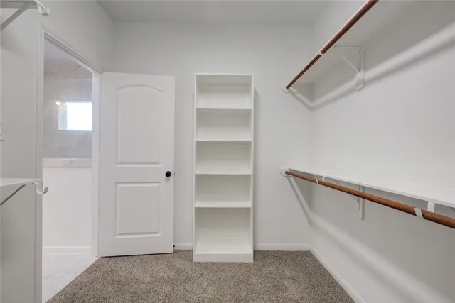 a bathroom with a granite countertop toilet and a sink