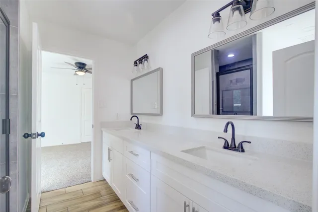 a bathroom with a shower and a sink