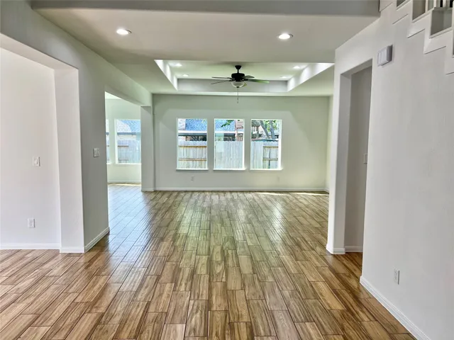wooden floor in an empty room with a window