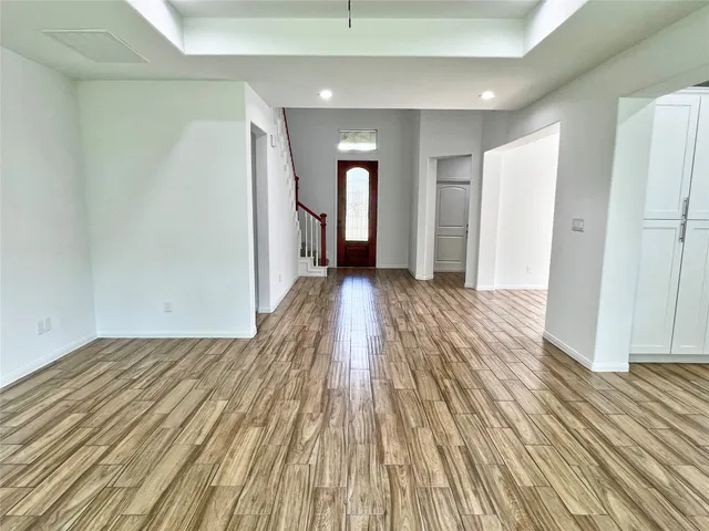 a view of a room with wooden floor and stairs