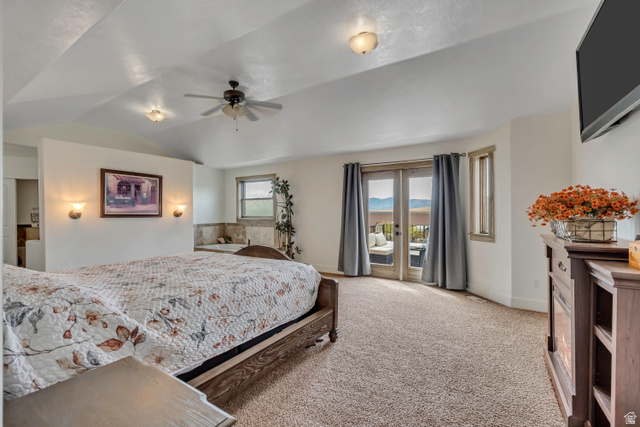 3054 West Ridgeline Road Stockton, UT 84071 - Photo 14 of 88 Bedroom with light carpet, access to exterior, vaulted ceiling, and a ceiling fan
