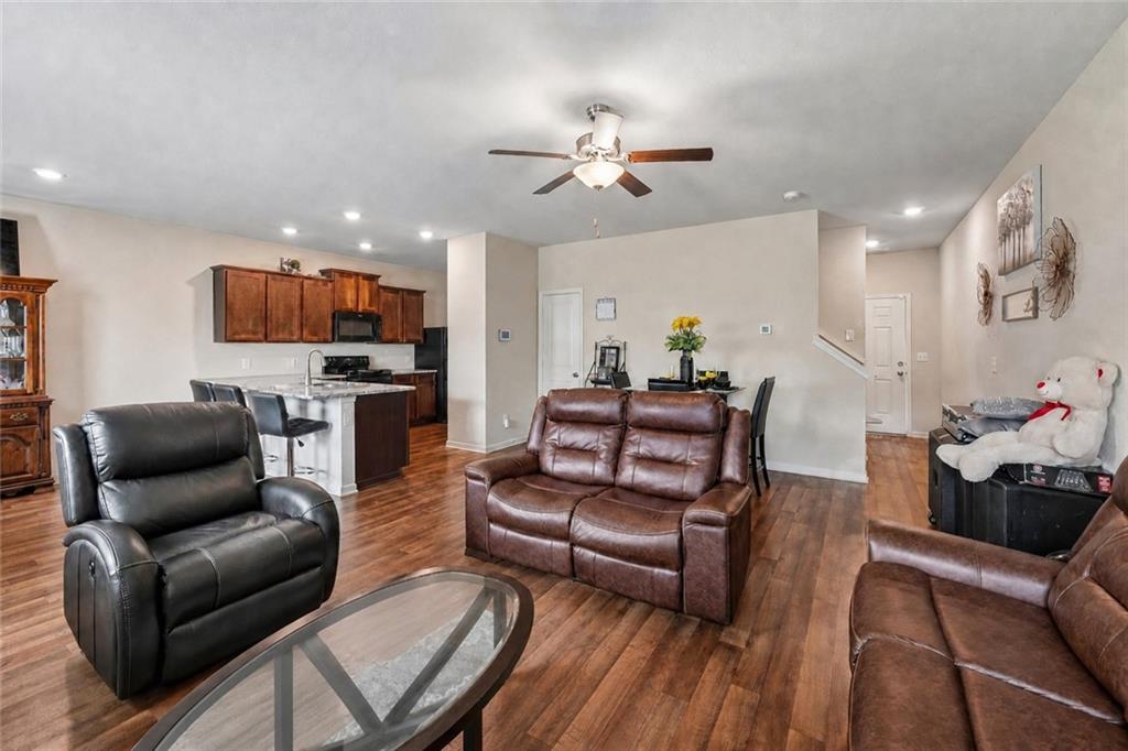 10933 Wheeler Trace Hampton, GA 30228 - Photo 9 of 22 a living room with furniture a fireplace and a flat screen tv