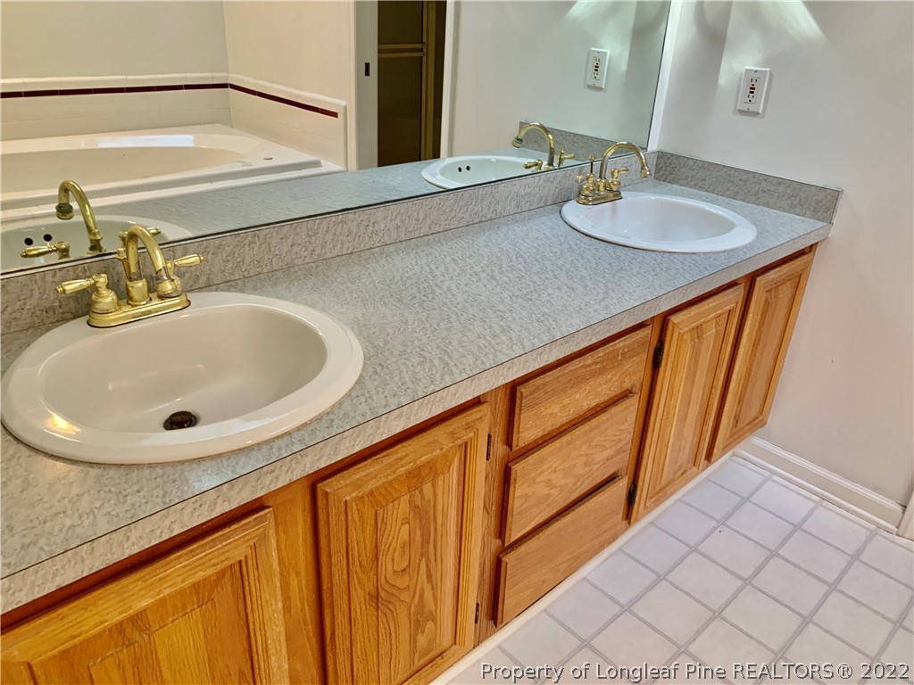 7800 Trappers Road Fayetteville, NC 28311 - Photo 11 of 20 a bathroom with a sink and a mirror