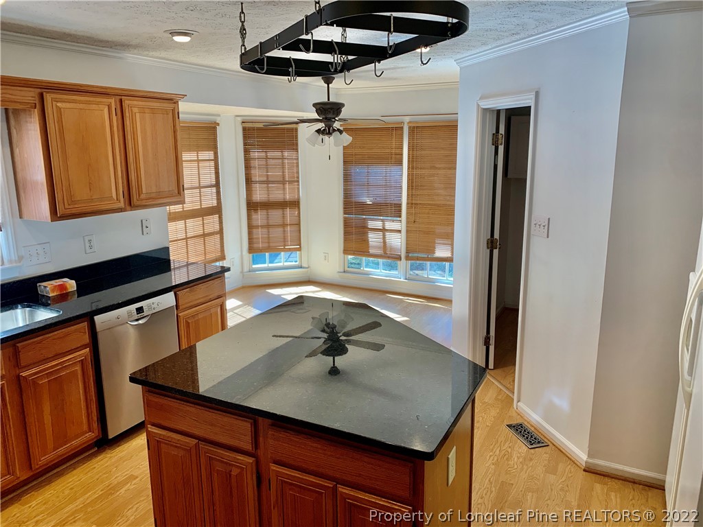 7800 Trappers Road Fayetteville, NC 28311 - Photo 6 of 20 a kitchen with a sink a counter top space and stainless steel appliances wooden floor
