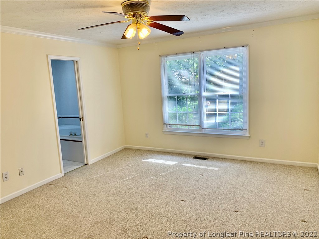 7800 Trappers Road Fayetteville, NC 28311 - Photo 9 of 20 an empty room with windows and fan