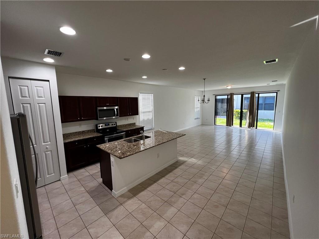 5542 Useppa Drive Ave Maria, FL 34142 - Photo 3 of 15 a large white kitchen with cabinets