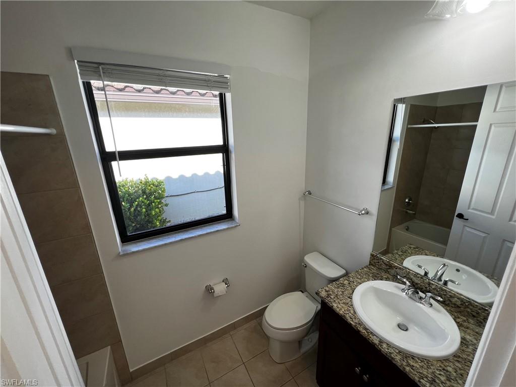 5542 Useppa Drive Ave Maria, FL 34142 - Photo 6 of 15 a bathroom with a sink toilet and mirror