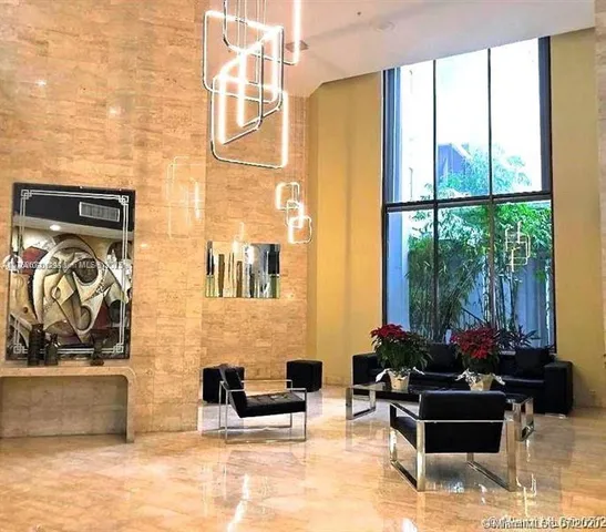 a living room with furniture and a floor to ceiling window