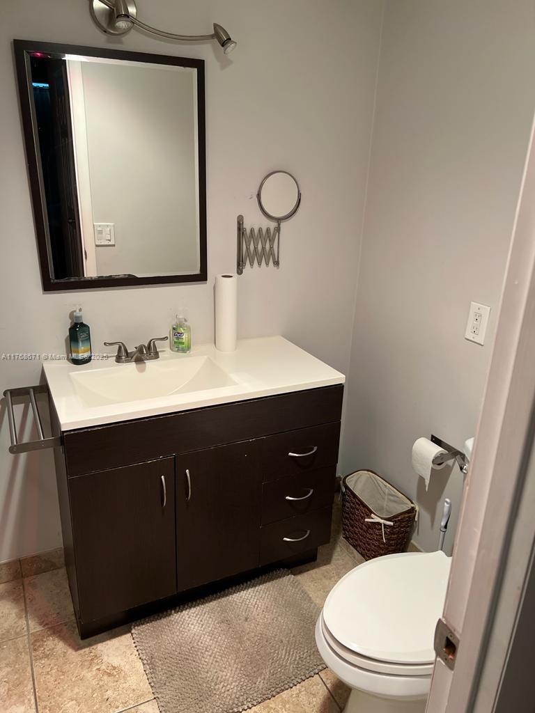 2750 Northeast 183rd Street, Unit 1207 Aventura, FL 33160 - Photo 4 of 21 a bathroom with a sink vanity mirror and toilet