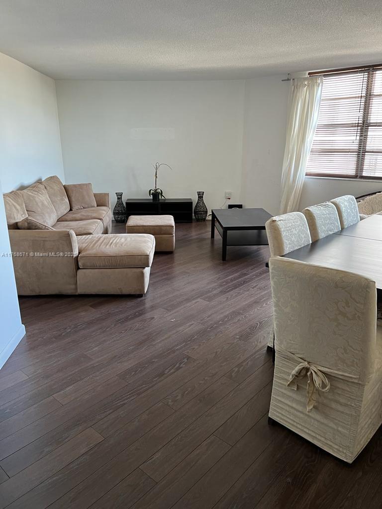 2750 Northeast 183rd Street, Unit 1207 Aventura, FL 33160 - Photo 9 of 21 a living room with furniture and a window