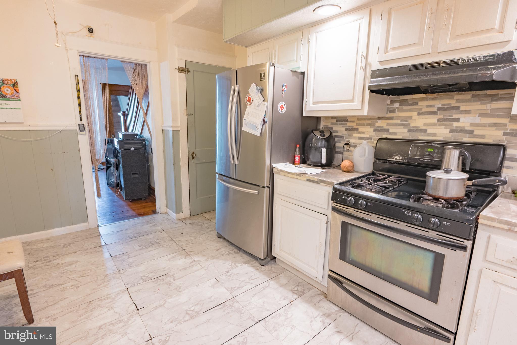 1020 Meade Street Reading, PA 19611 - Photo 11 of 28 a kitchen with a stove and a refrigerator