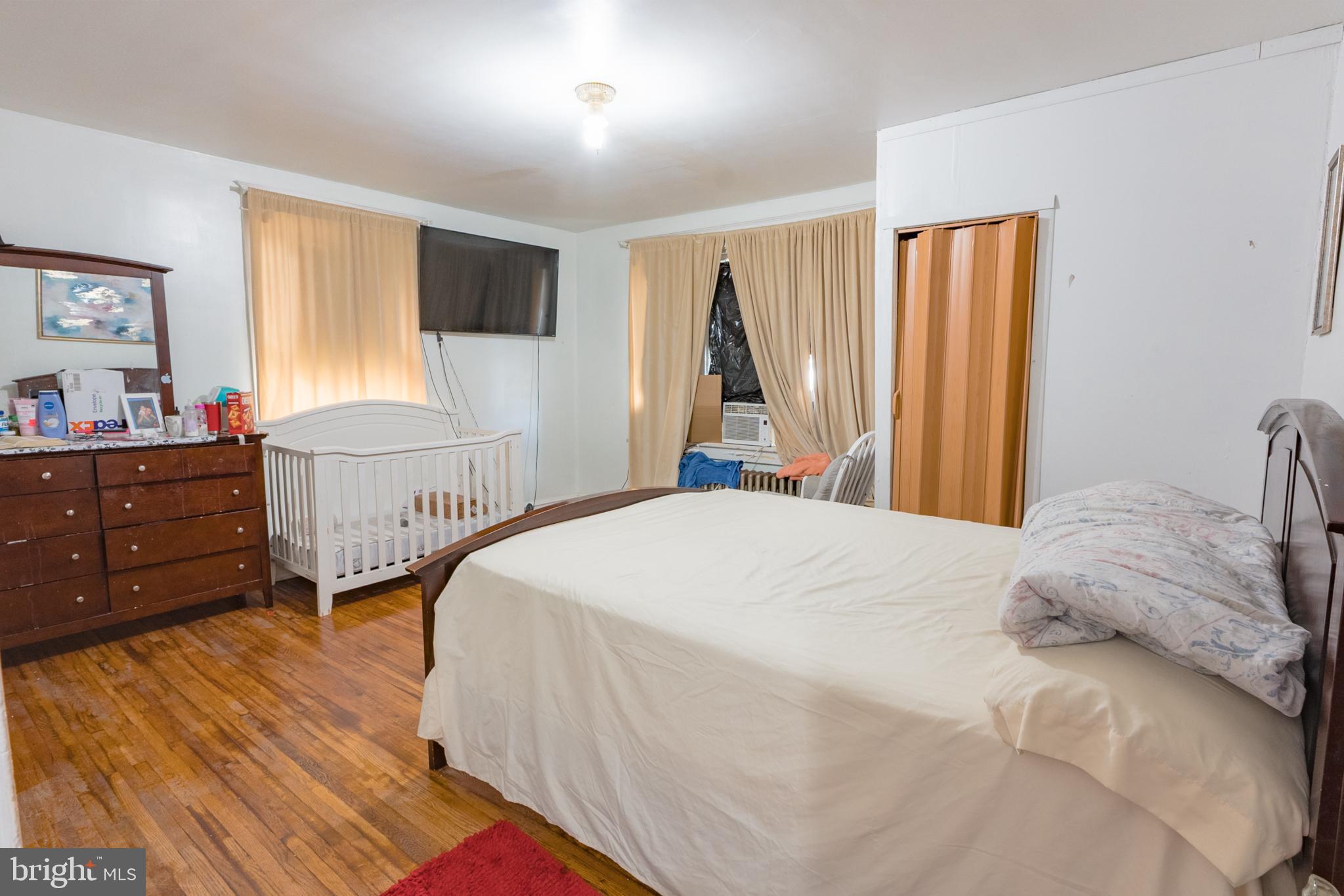 1020 Meade Street Reading, PA 19611 - Photo 13 of 28 a bedroom with a bed and a flat tv screen on dresser