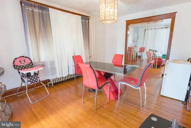 a dining room with furniture and wooden floor