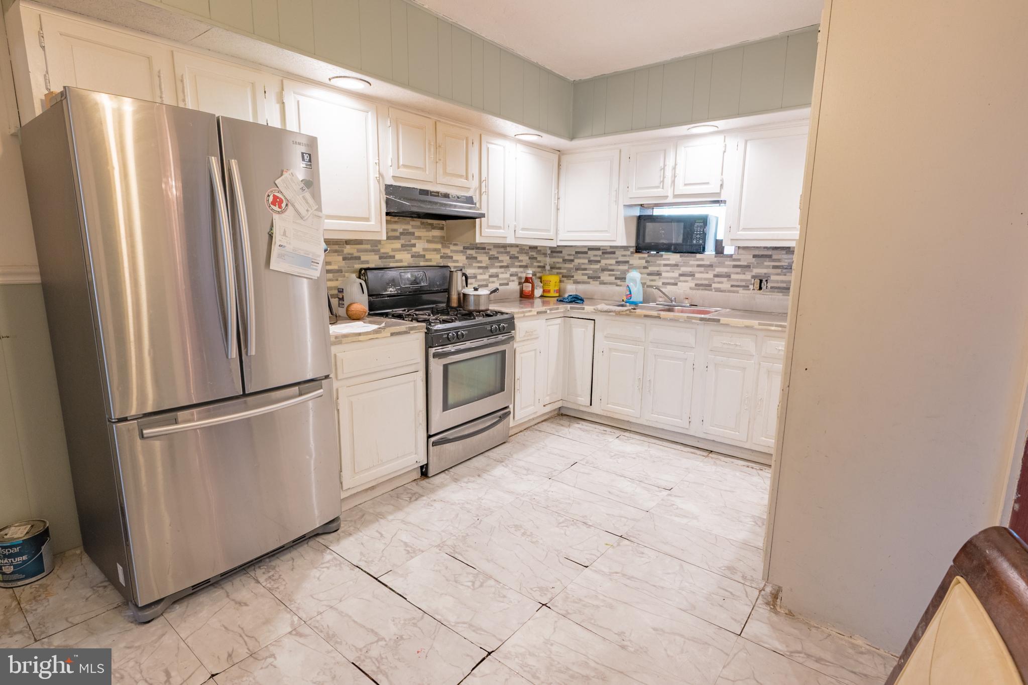 1020 Meade Street Reading, PA 19611 - Photo 10 of 28 a kitchen with stainless steel appliances granite countertop a refrigerator stove a sink and a microwave
