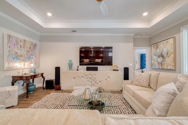 a living room with furniture a rug and a flat screen tv