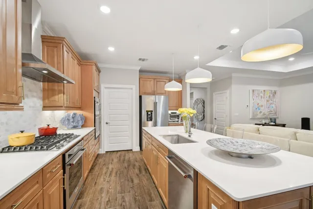 a kitchen with stainless steel appliances kitchen island granite countertop a sink stove and cabinets