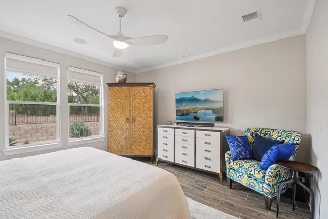 a bedroom with a bed and large windows