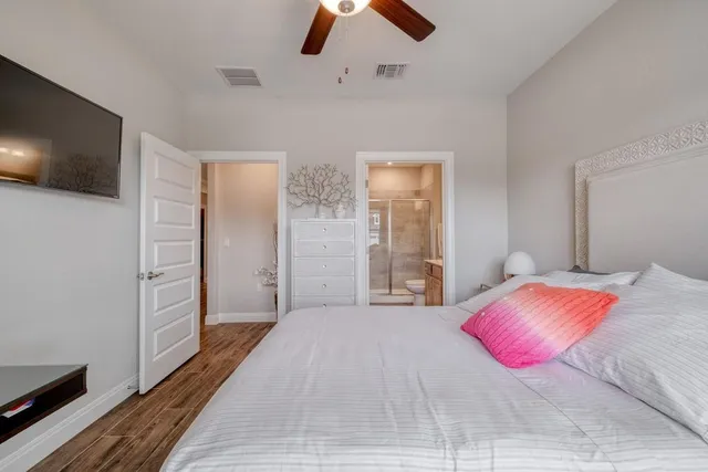 a bedroom with a bed and a flat screen tv