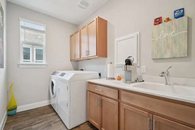 a utility room with a sink dryer and washer