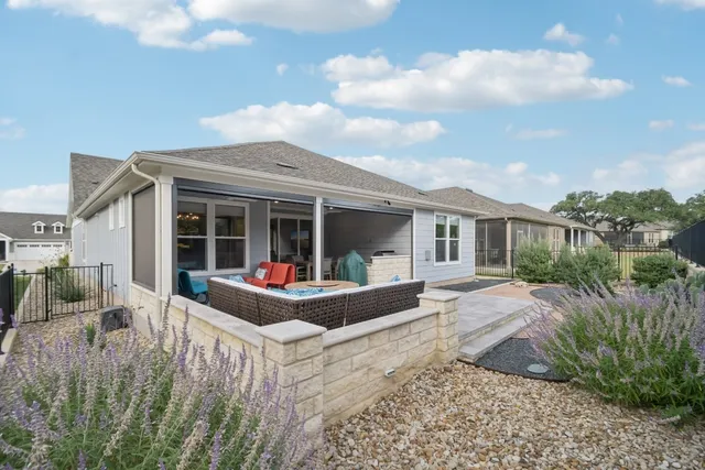 a front view of a house with porch and garden