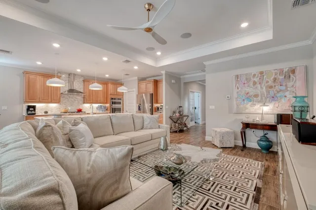 a living room with furniture and kitchen view