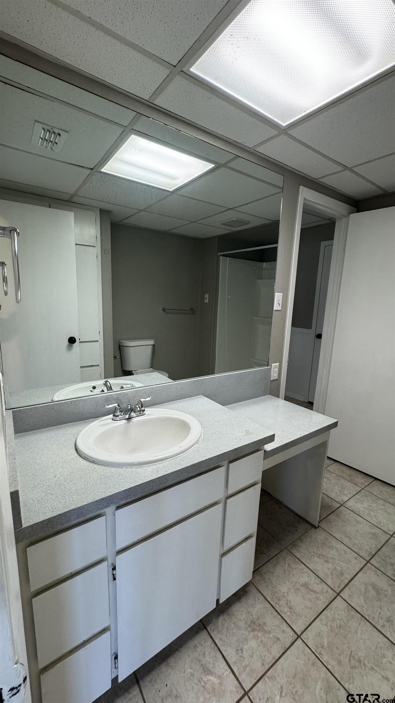 4584 Sunrise Drive Chandler, TX 75758 - Photo 15 of 28 a bathroom with a sink and a mirror