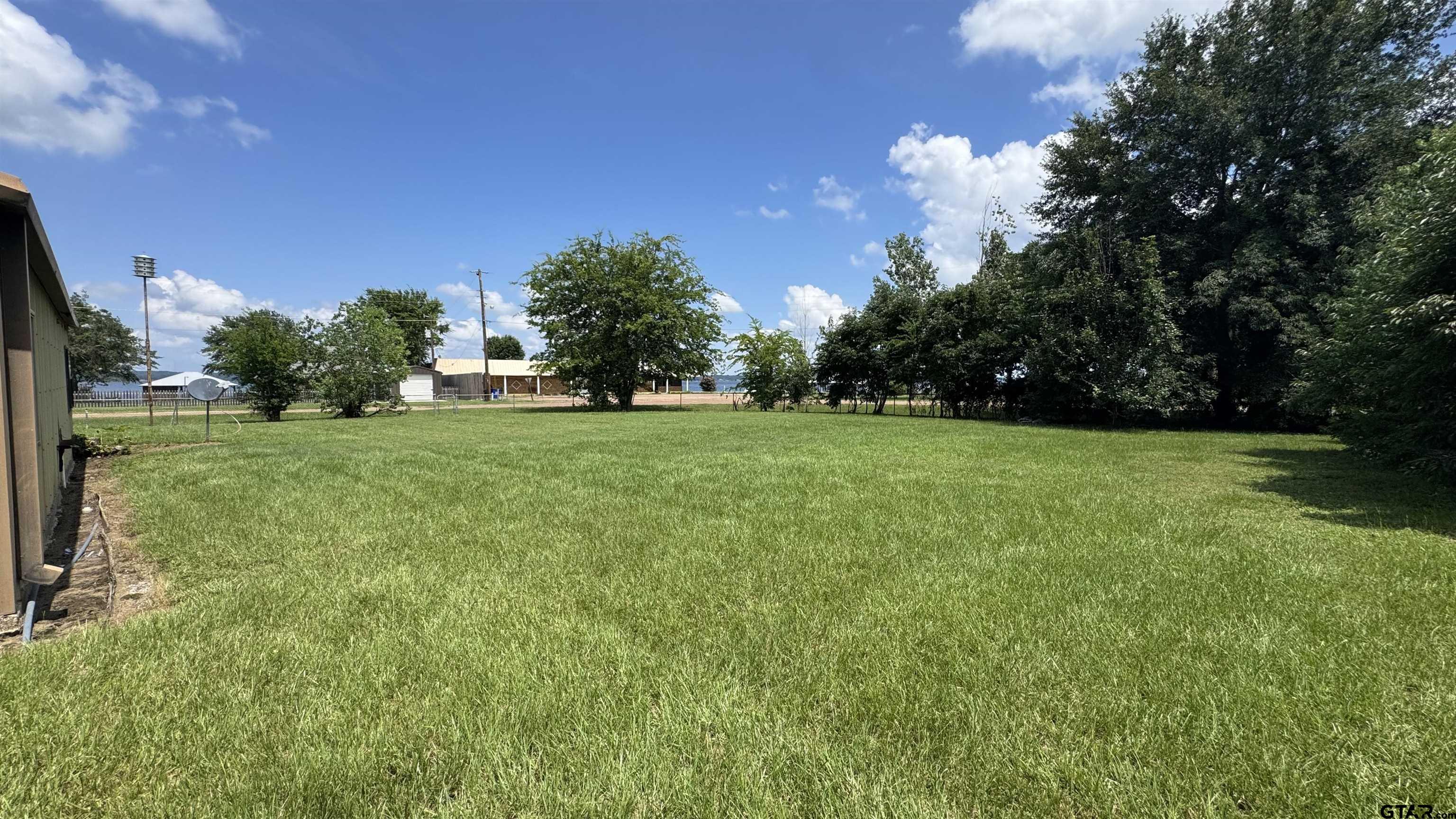 4584 Sunrise Drive Chandler, TX 75758 - Photo 26 of 28 a view of a big yard with a house in the background