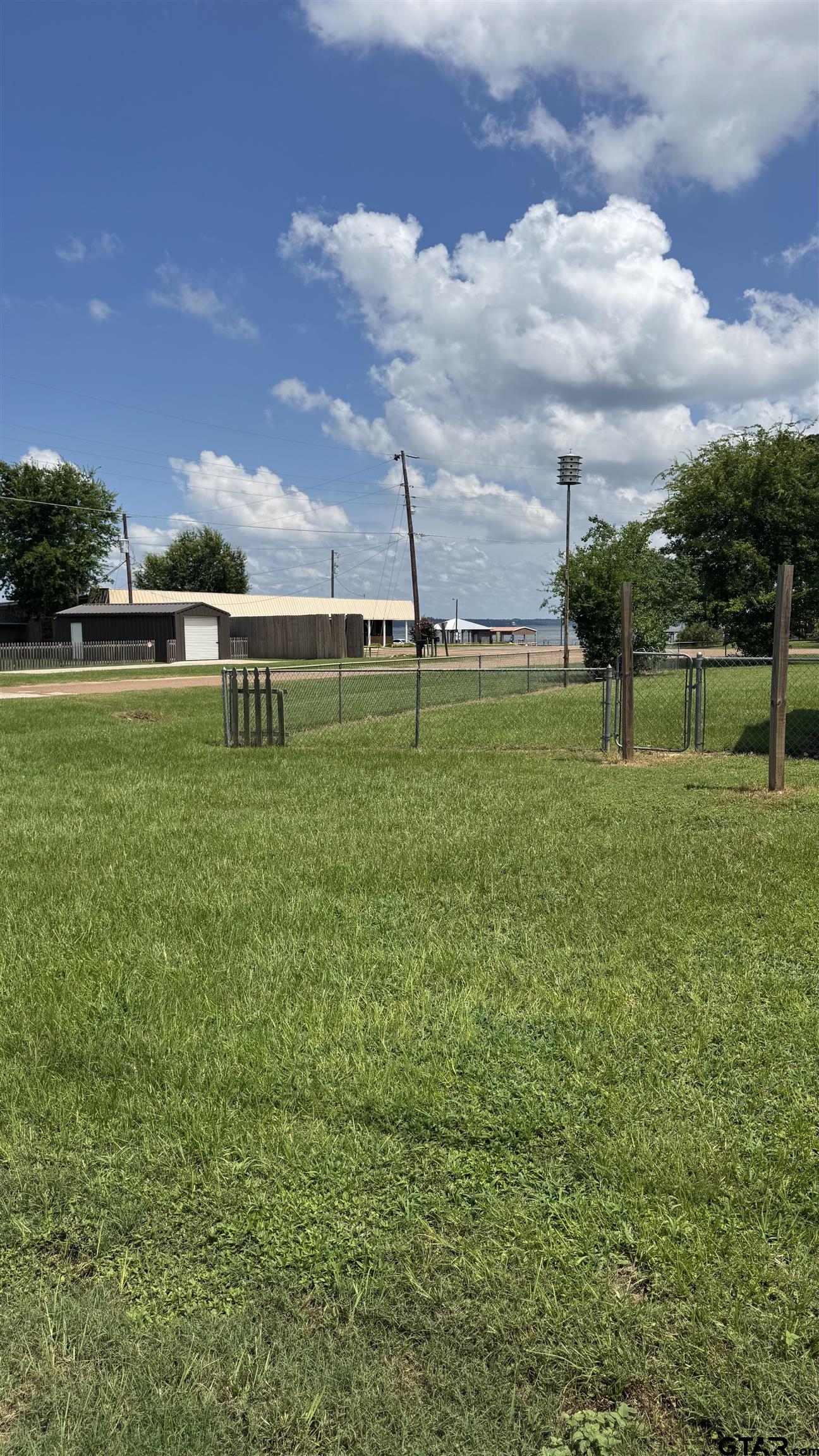 4584 Sunrise Drive Chandler, TX 75758 - Photo 27 of 28 a view of a golf course with a lake