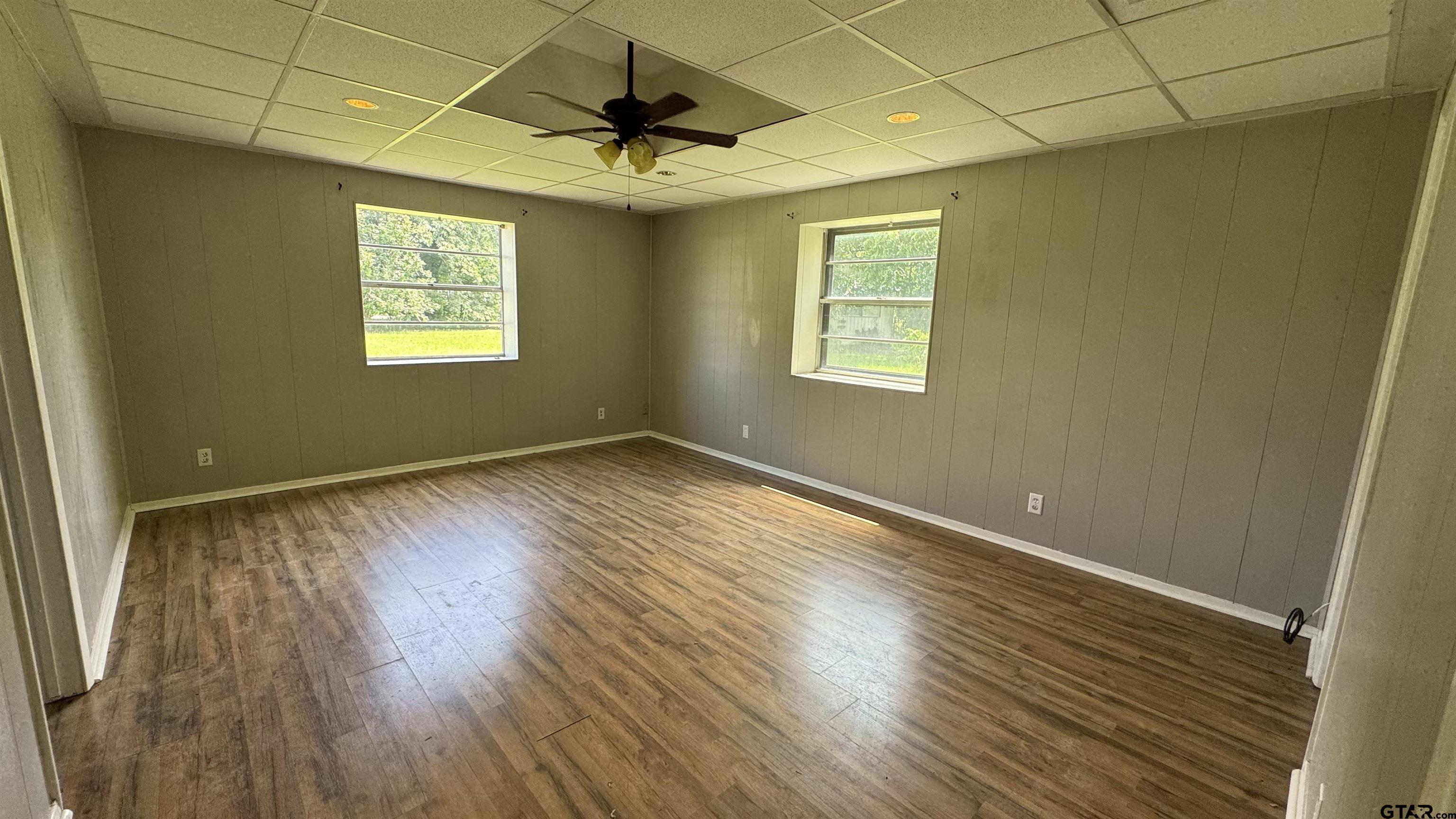 4584 Sunrise Drive Chandler, TX 75758 - Photo 9 of 28 a view of an empty room with wooden floor and a window