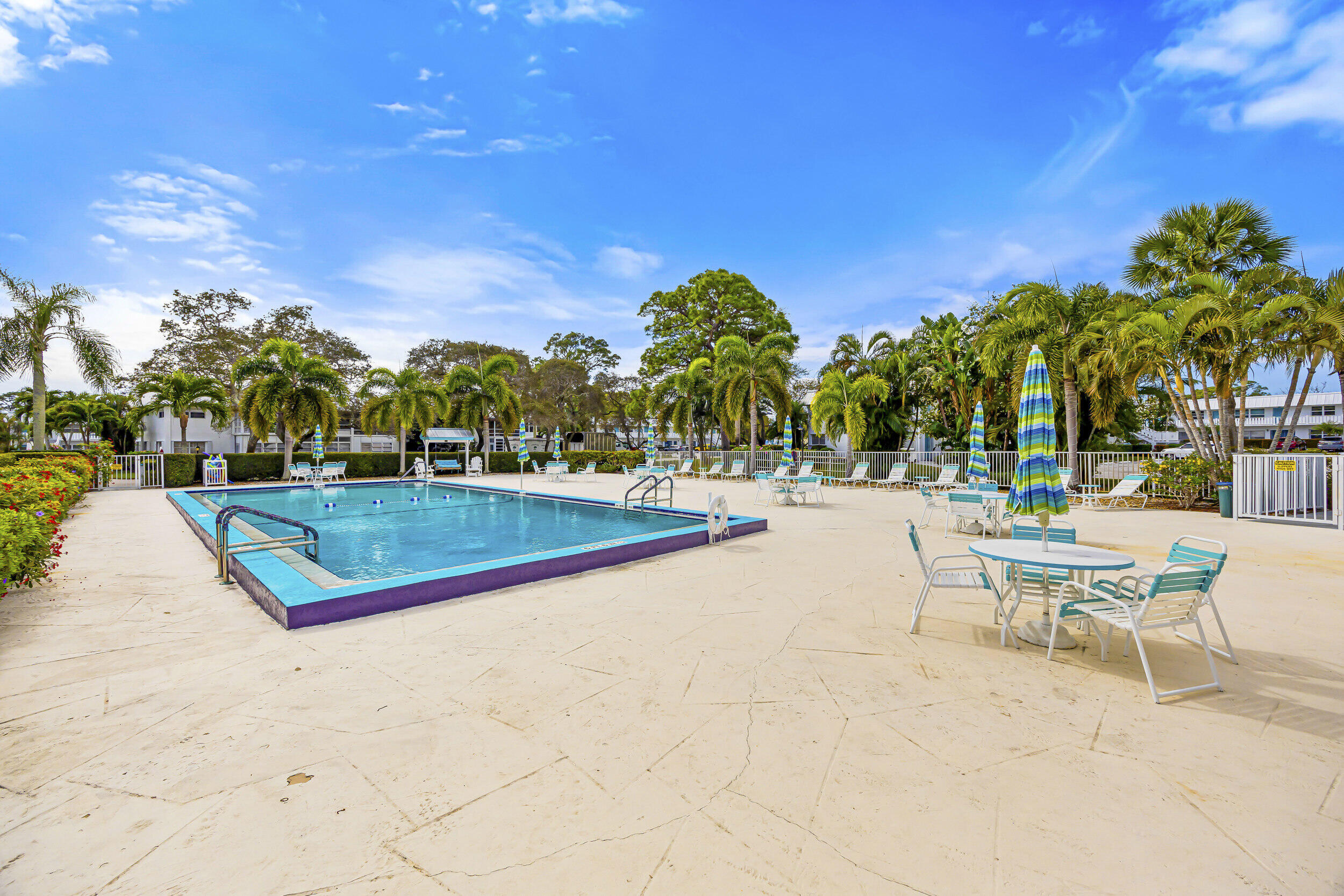 2929 Southeast Ocean Boulevard, Unit 10510 Stuart, FL 34996 - Photo 22 of 37 a view of a swimming pool with a lounge chair