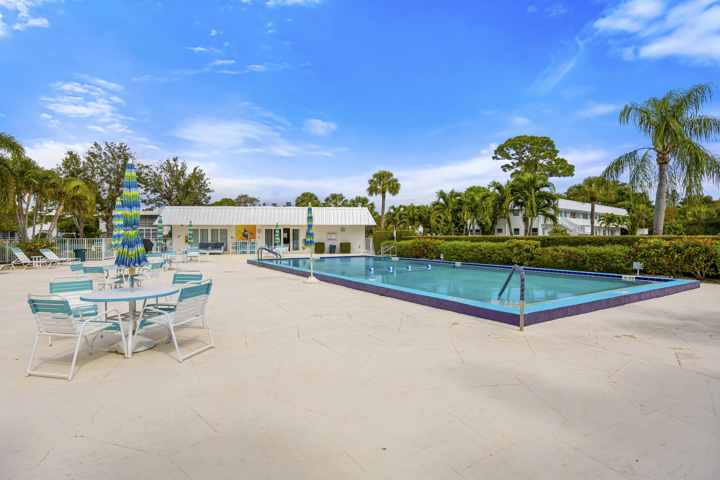 2929 Southeast Ocean Boulevard, Unit 10510 Stuart, FL 34996 - Photo 23 of 37 a swimming pool with outdoor seating and yard