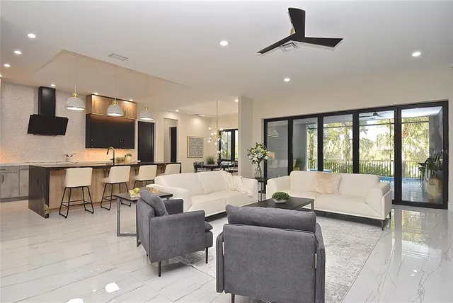 a view of an empty room with a window and a ceiling fan